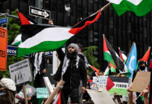 The One Issue Breaking Washington’s Old Israel Consensus Protesters with flags and signs, one holding a megaphone.