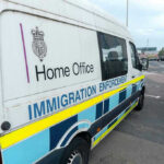 ICE: Fairfax Ignored 3 Detainers, Man Now Accused of Murder White immigration enforcement van parked by roadside