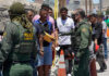 Protests Erupt After Fatal ICE Shooting Border patrol agents inspecting group of individuals in line.