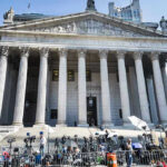 Counterterror Takeover, Facts Go Dark Courthouse facade with media crews setting up outside.