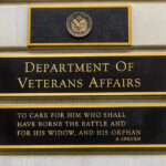 A Faster Path to Psychedelic Treatment Leaves Millions Waiting Department of Veterans Affairs building sign with quote.
