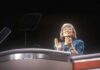 Hypocrisy Charge Backfires: CNN Debate Turns Into a Fight A female speaker on stage smiling and clapping during a presentation