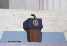 Biden’s July 4 ‘Unity’ Message Reignites Autopen Controversy Podium with a microphone and presidential seal in front of steps