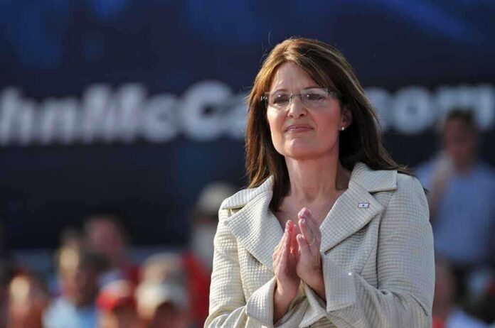 shutterstock_16791280 A female politician clapping at a political rally