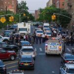 Man Fighting for Life After Police Recruiter’s Car Strike Police vehicles and officers block a city street during an active scene