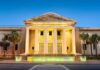 Supreme Court building with illuminated columns at dusk