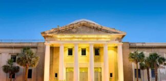 Supreme Court building with illuminated columns at dusk