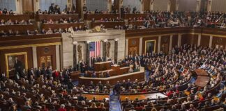 Legislative chamber filled with attendees during a formal address
