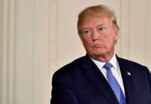 Trump Warns Nations Helping Iran man in suit with blue tie looking to the side