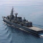 Modern naval warship cruising on calm sea