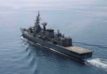 Modern naval warship cruising on calm sea