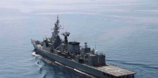Modern naval warship cruising on calm sea