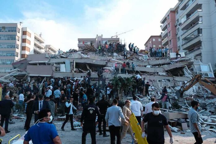 Rescue workers and civilians on collapsed building after earthquake