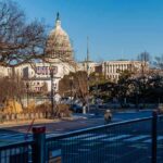 U.S. Capitol building behind security fencing and a quiet street