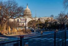 National Parks Funds Diverted to D.C. U.S. Capitol building behind security fencing and a quiet street