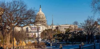 U.S. Capitol building behind security fencing and a quiet street