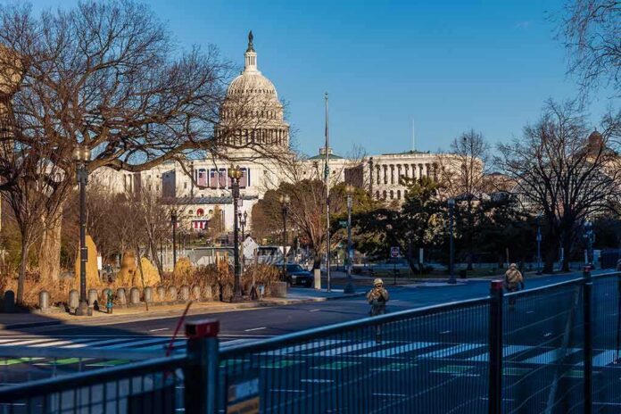 shutterstock_1898228902 U.S. Capitol building behind security fencing and a quiet street