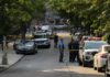 Brussels Struggles to Stop Drug Gang Violence Police officers secure a residential street with patrol cars and yellow tape