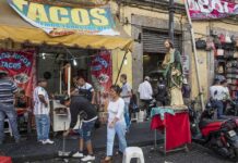 9,746 L.A. Street-Food Complaints Raise Safety Concerns Street taco stand with people and a religious statue