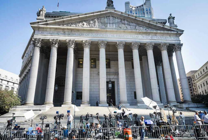 2445868619-1 Reporters and photographers gathered outside a neoclassical courthouse
