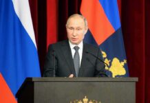 Russia Wants Today’s Front Lines Recognized Vladimir Putin speaking at a podium with microphones