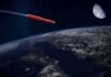 Navy Unveils “Malice” Long-Range Missile Red rocket flying above Earth toward the Moon