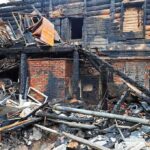 Burned building facade with charred debris