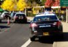 Chilling River Find Sparks Chase Mystery Police cars with lights on near school buses on a city street