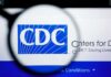 CDC Reports Zero Measles Deaths in 2026 Magnifying glass over CDC logo on a computer screen