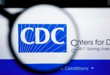 CDC Reports Zero Measles Deaths in 2026 Magnifying glass over CDC logo on a computer screen
