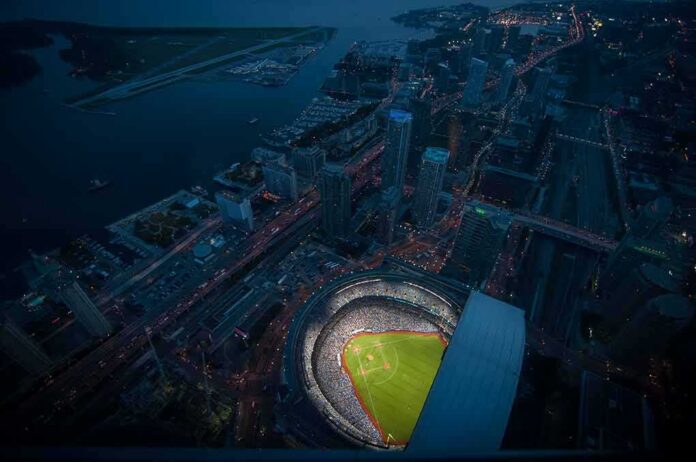 Baseball stadium illuminated at night in a coastal city