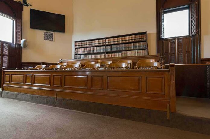 shutterstock_1589332936 jury box in an empty courtroom