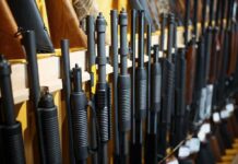 New Bill Could Put Some Airguns Under Federal Gun Rules Shotguns and rifles lined up on a rack in a gun store