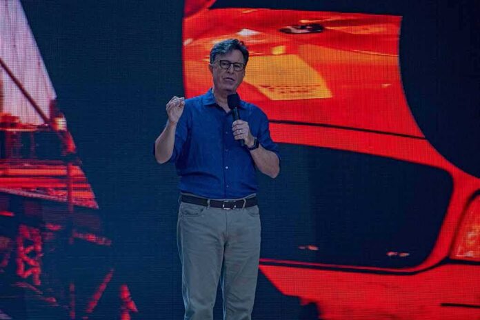 man giving a talk on stage with microphone