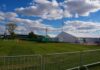 Security Planning Falls Short at UVU Temporary white tents and equipment on a grassy field with traffic cones and metal barriers