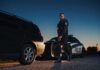 911: Fake Cop Calls Real Police Police officer standing near patrol car during twilight traffic stop