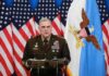 Trump Names Acting Army Secretary Military officer speaks at podium with U.S. flags behind