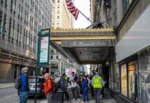 NYC Sewer Incident Triggers Manhunt Andreas Hestler and pedestrians outside The Roosevelt Hotel entrance on a city sidewalk