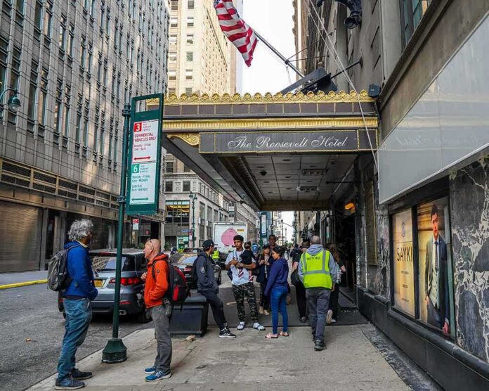shutterstock_2307792205 Andreas Hestler and pedestrians outside The Roosevelt Hotel entrance on a city sidewalk