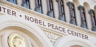 Nobel Peace Center facade with arched windows and gold medallion