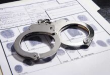 10,000 Extremist Files Allegedly Shared Handcuffs on a fingerprint record form