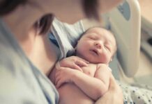 Billionaire’s Surrogacy Plans Raise New Concerns newborn baby sleeping in a parent's arms