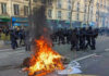 15-Year-Old Arrested After Woman Burned in Marseille Fire burning on the street amid police presence.