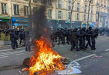 15-Year-Old Arrested After Woman Burned in Marseille Fire burning on the street amid police presence.