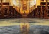 Ecuador Priest Dies During Livestreamed Mass Church interior with wooden pews facing ornate altar