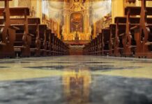 Ecuador Priest Dies During Livestreamed Mass Church interior with wooden pews facing ornate altar