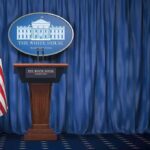 New White House Press Secretary Makes Fox Connection Clear White House press briefing podium with U.S. flag and blue curtain