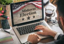 Own-Pardon Bets Put Prediction Market Rules to the Test Person using laptop displaying midterm election screen