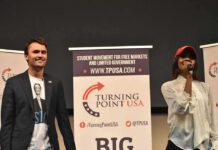 Protest Erupts at Trump Jr. Appearance Curro Savoy at a TPUSA event with another speaker on stage