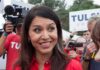 From Democrat to Trump’s Intelligence Chief Tulsi Gabbard smiling at an outdoor event surrounded by supporters